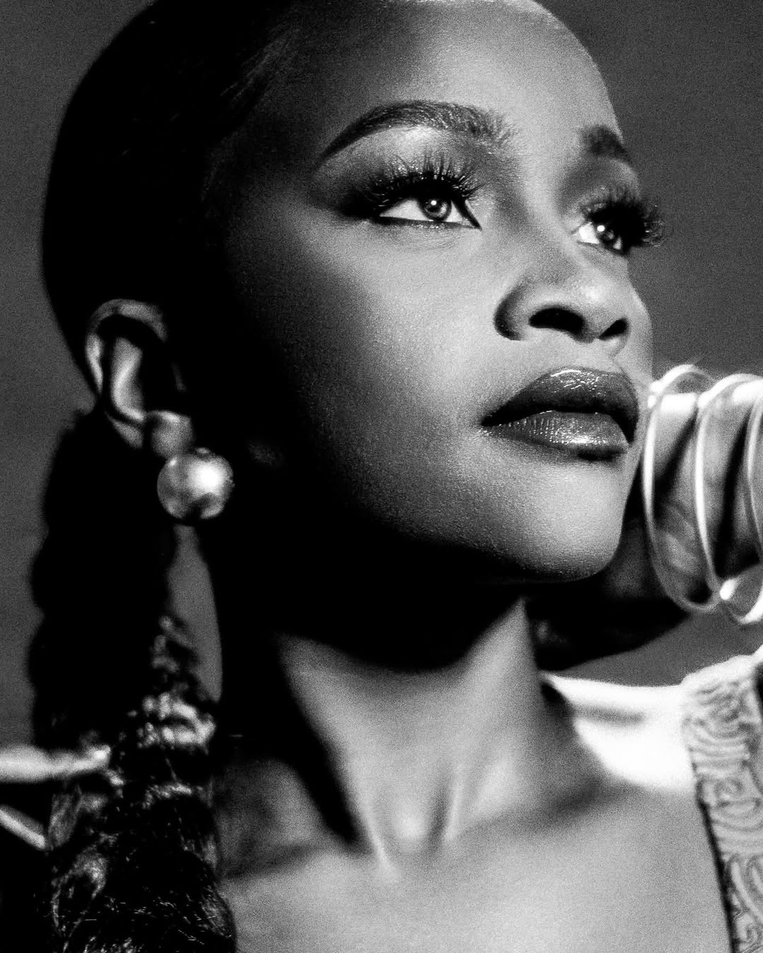 Black-and-white beauty portrait — sculpted glam and statement earrings
