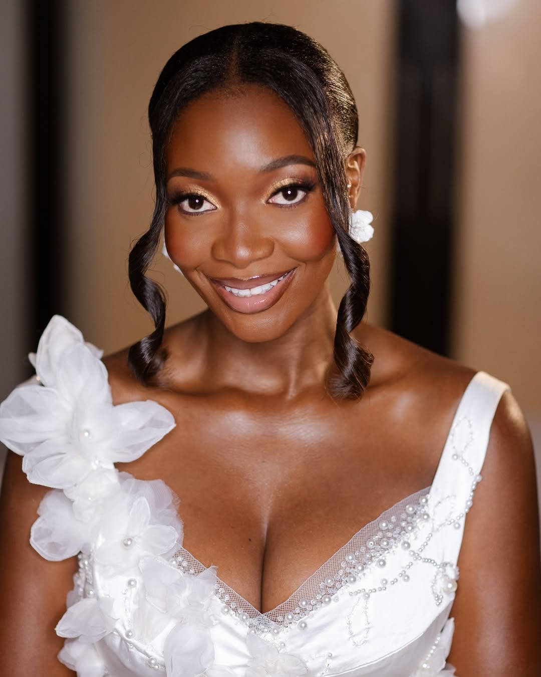 Smiling bride with soft glam and floral gown