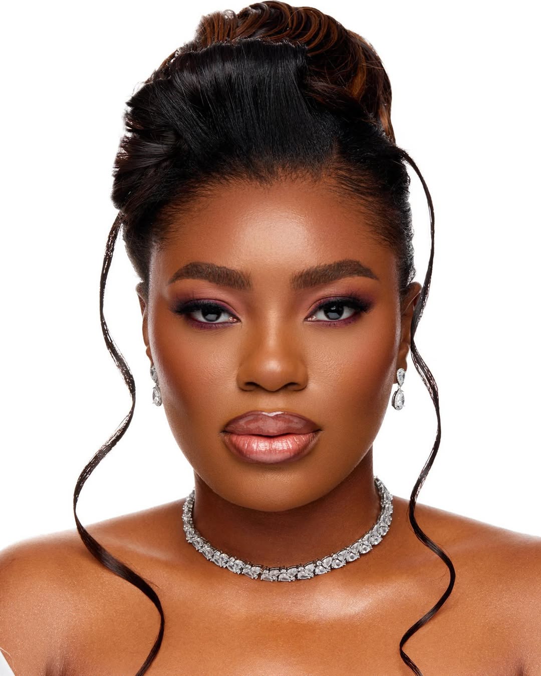 Soft bridal glam with a sculpted updo and diamond necklace