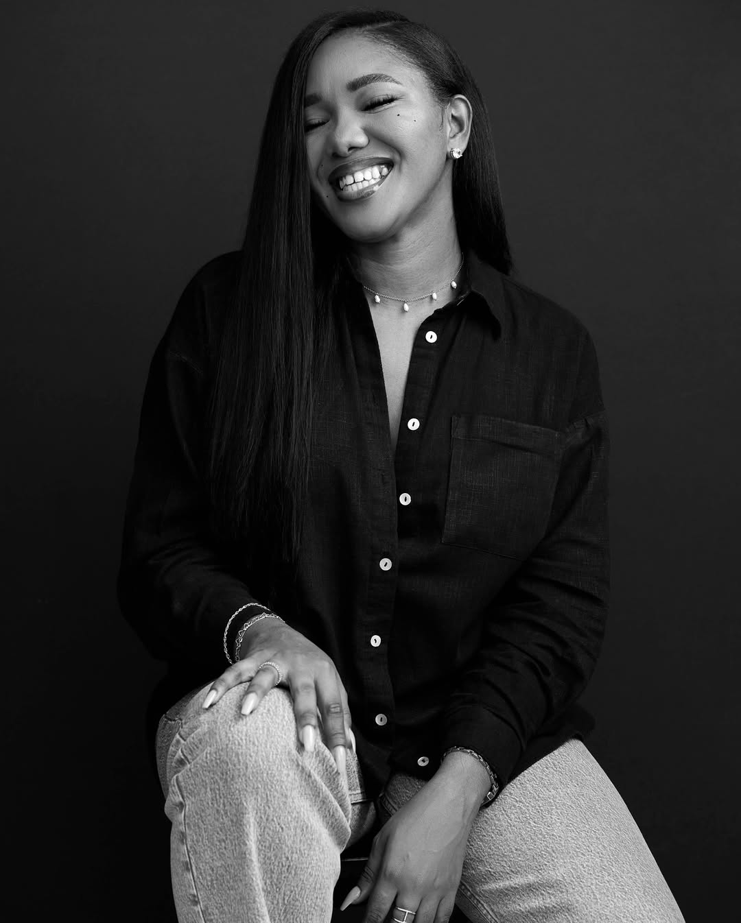 Kaladata smiling, seated, in a black shirt