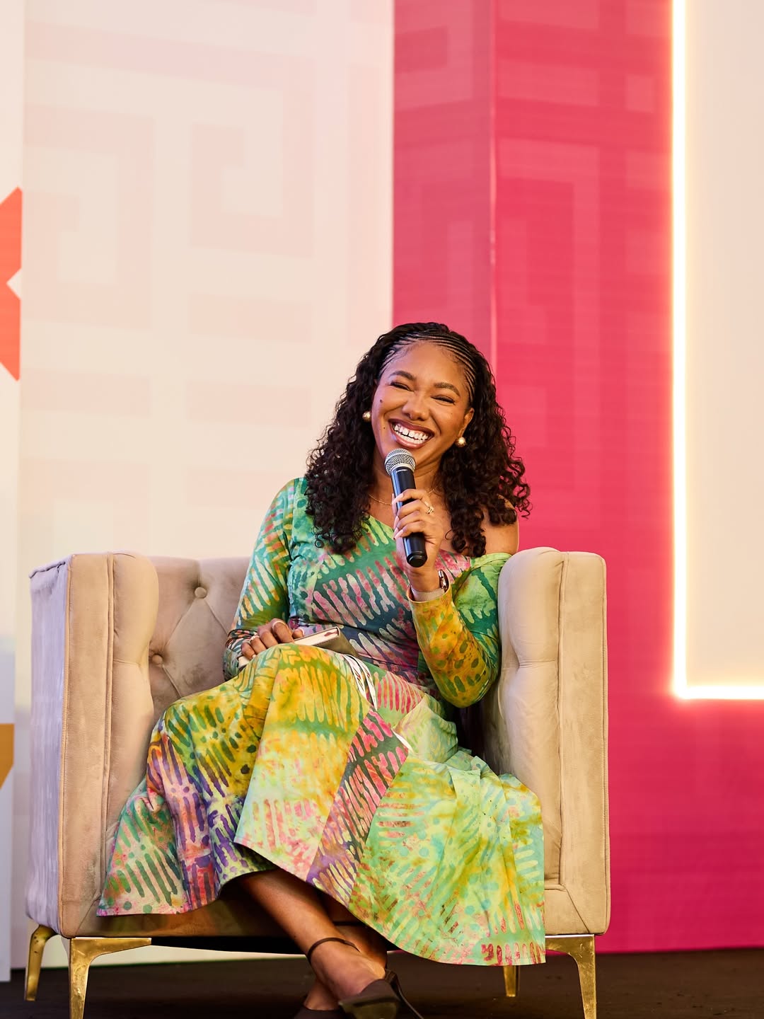 Kaladata seated on stage with a microphone
